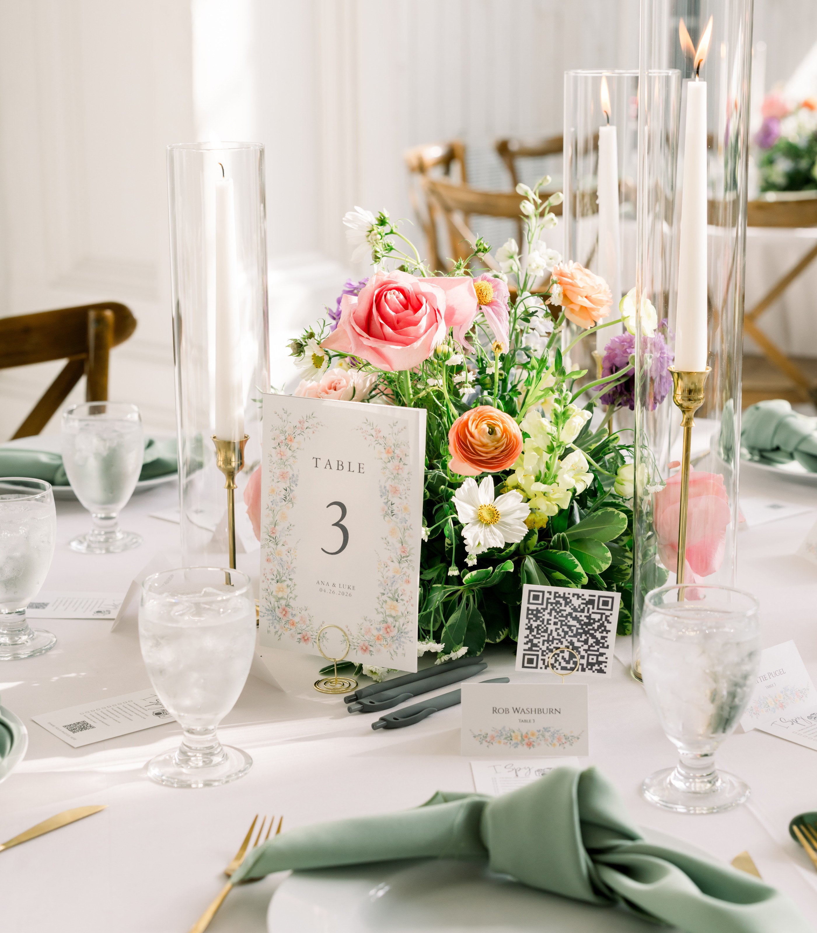 Centerpiece at The White Sparrow in coral, pink, and peach garden roses with trailing greenery, set on a round reception table, by B.blumen