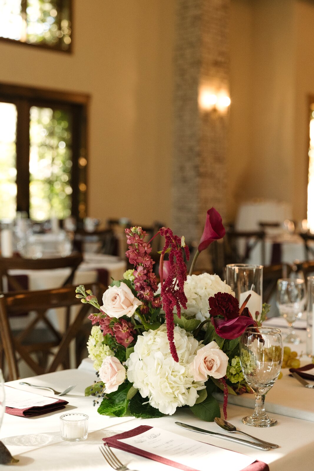 Reception centerpiece at The Springs Waxahachie with white roses, hydrangea, and trailing red amaranthus by B.blumen