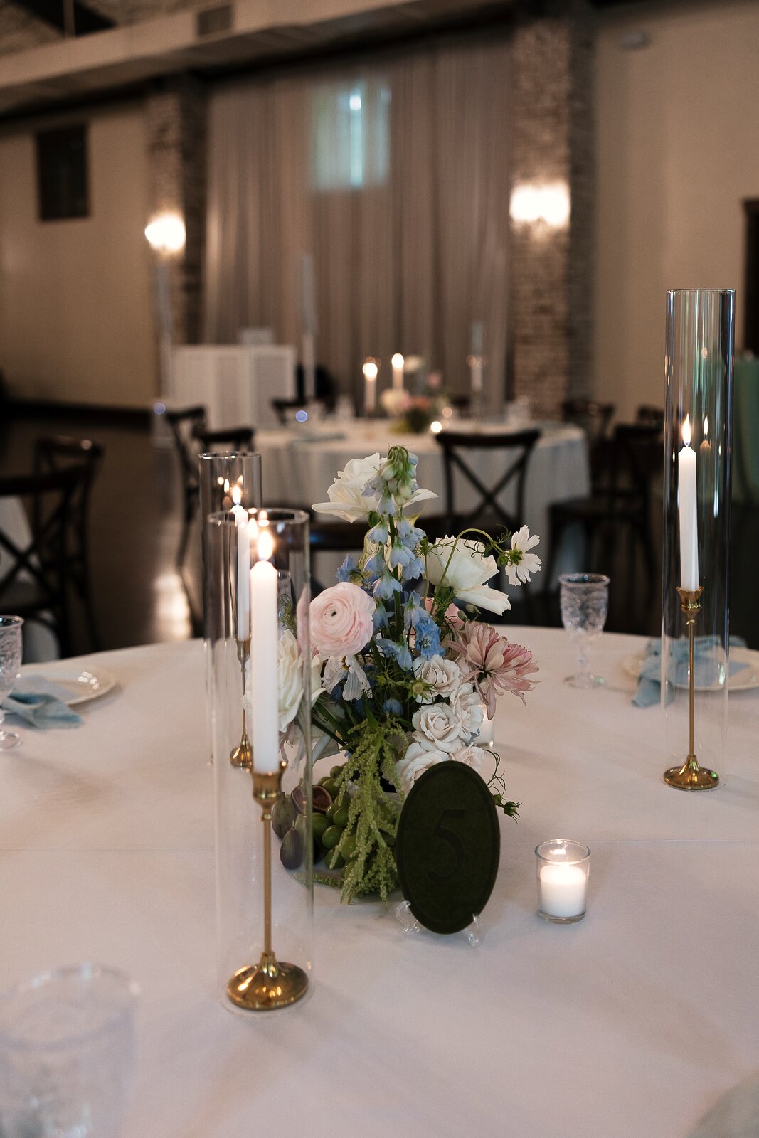 Pastel reception centerpiece at The Springs Waxahachie with white roses and pink florals by B.blumen