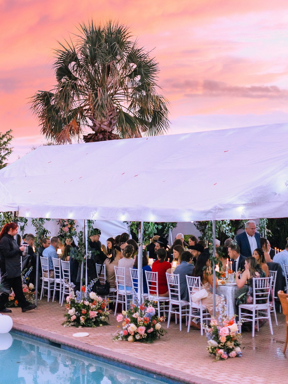 Tented dinner at dusk under string lights