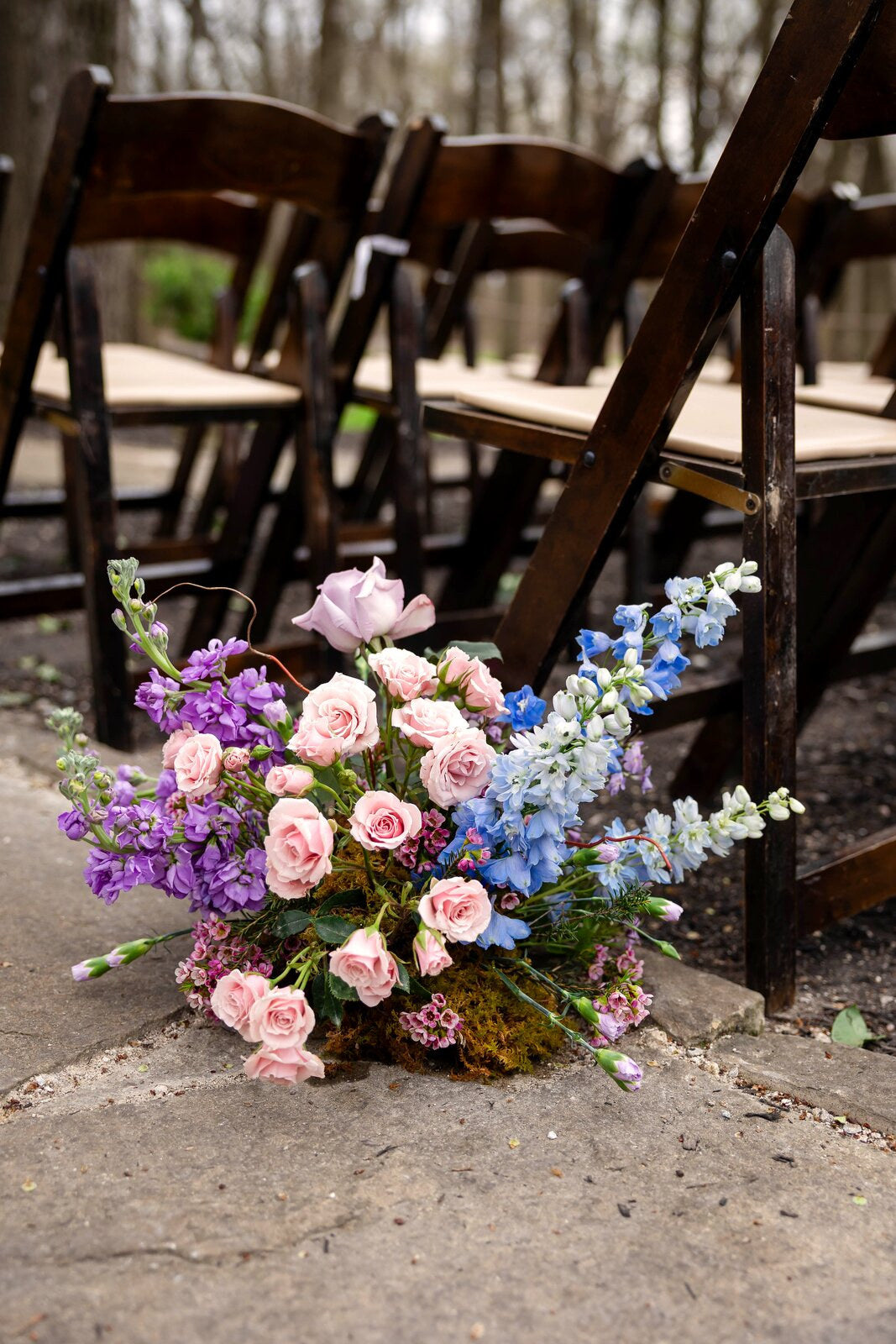 Close detail of an aisle-marker arrangement at The Springs Waxahachie in pink, purple, and blue florals by B.blumen