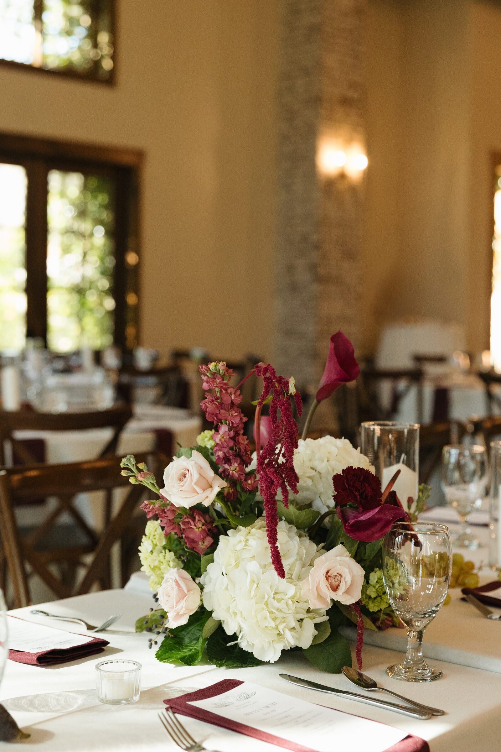 Reception centerpiece at The Springs Waxahachie with white roses, hydrangea, and trailing red amaranthus by B.blumen